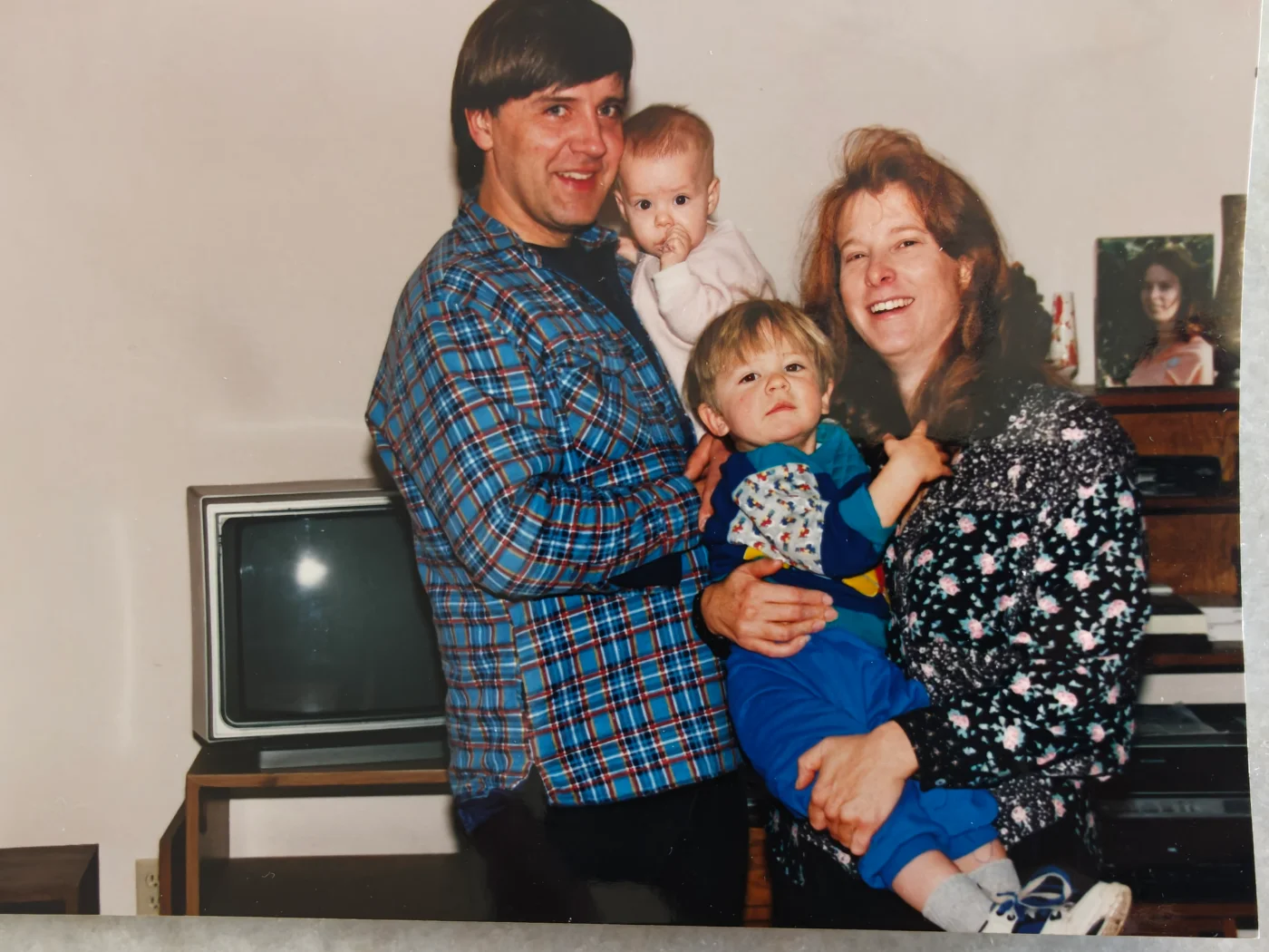 A photograph from the early 1990s of Ed and Dianne at home, each holding one of their two young children